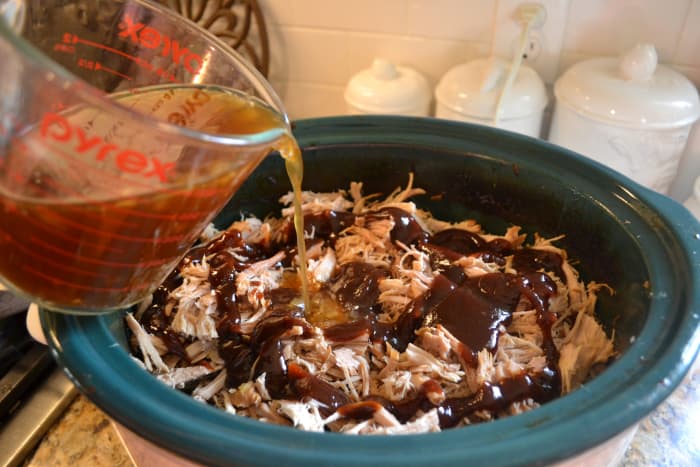 Add the amount of BBQ sauce and broth you prefer. I typically start with one 18-ounce bottle of BBQ sauce and about one cup of broth, and add more from there if needed.
