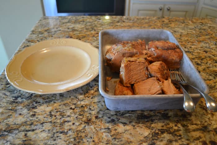 A cutting board works well for pulling meat, but I tend to use a pan in order to contain the juices. A plate is useful for holding any skin, fat, gristle, or bones you remove.