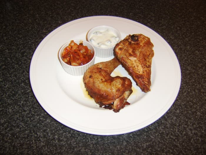 Dry marinated tandoori chicken is roasted and served with spiced onions and yoghurt based Indian raita