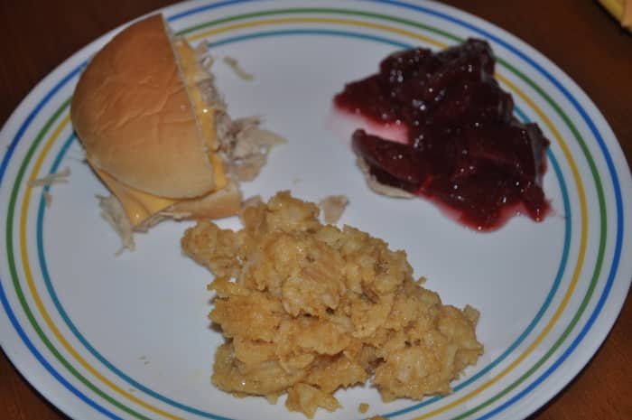 With tasty side dishes, you can offer your guests a complete meal they will rave about. Pictured with the cheesy potatoes is a turkey gravy sandwich with cheese and cranberries.