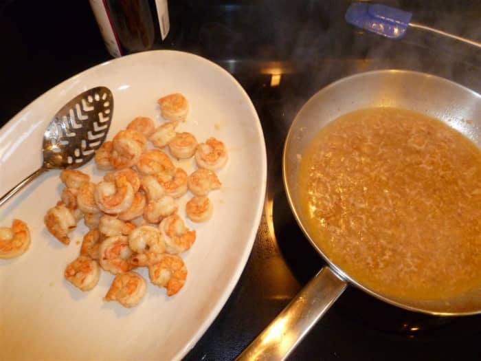 Using a slotted spoon, remove the shrimp from the oil so you can reduce the oil and sherry mixture without overcooking the shrimp.