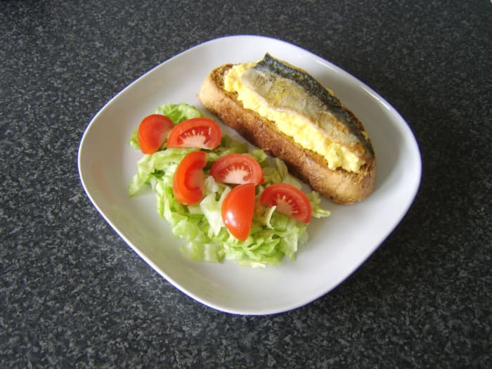 Simple pan fried mackerel fillet and scrambled eggs are included on wheat, spelt and rye toast and served with a simple salad