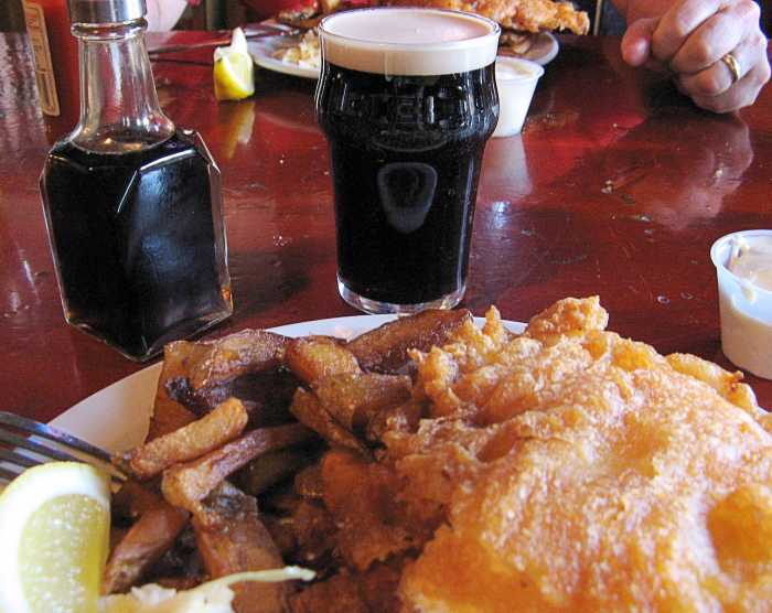Fish and chips, Guinness, and malt vinegar