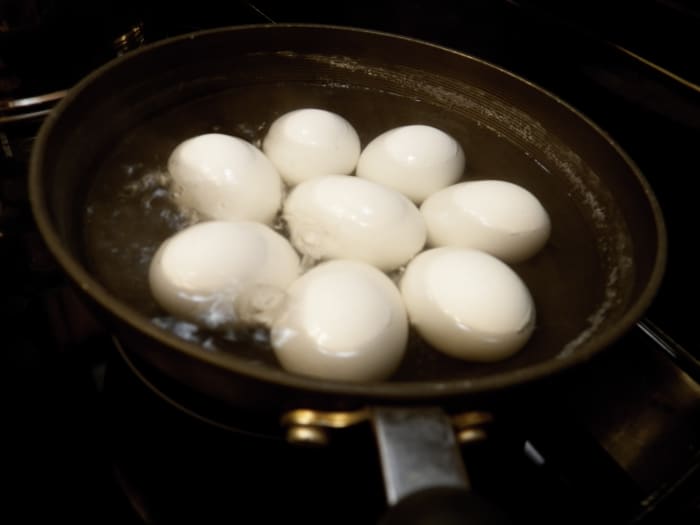 Step 1: Cover eggs with water in pan. Put on stove. Heat to boiling. Boil 12 minutes. Take off the stove and pour off the hot water. Put eggs in ice water (which helps the shell to separate from the egg and makes peeling easier).