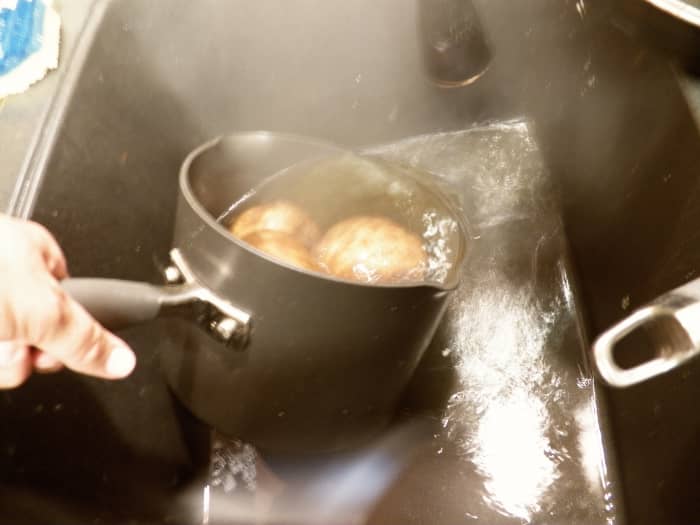 Step 5: Prepare potatoes. When potatoes are done, pour off hot water and fill pan with cold water until potatoes can be handled.