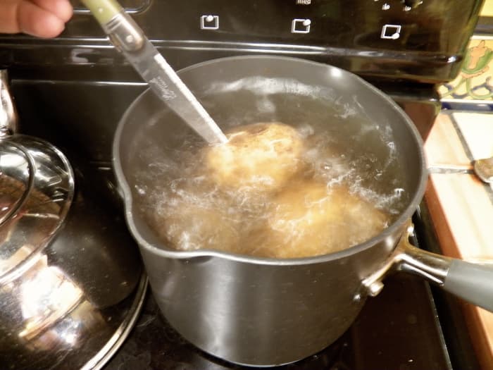 Step 2 (do at the same time as step 1): Cover potatoes with water in pan. Put on stove. Heat to boiling. Boil 20-30 minutes or until knife goes into potato easily and skin peels back.
