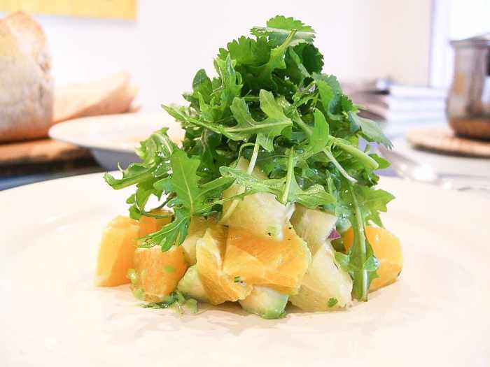 Avocado, grapefuit, and orange salad with red onion, arugula and cilantro