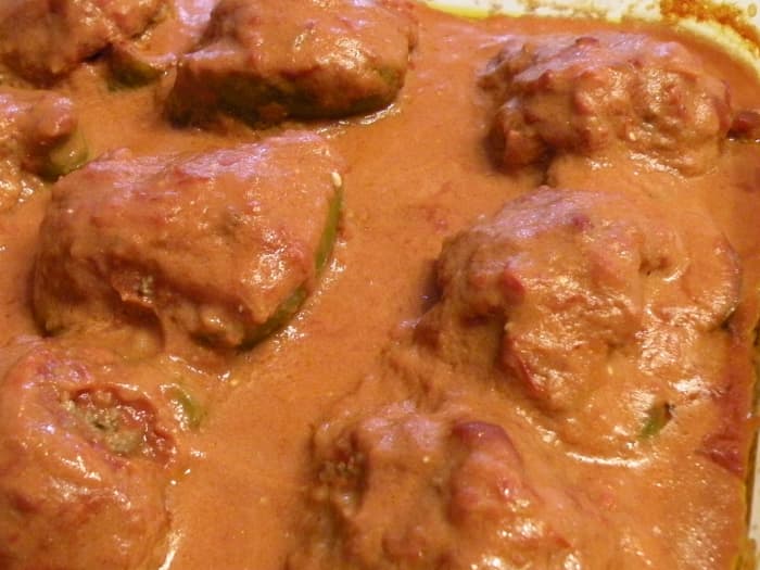 Ladle out tomato sauce from baking dish and whisk in 2/3 cup sour cream. Pour over baked stuffed peppers and serve.