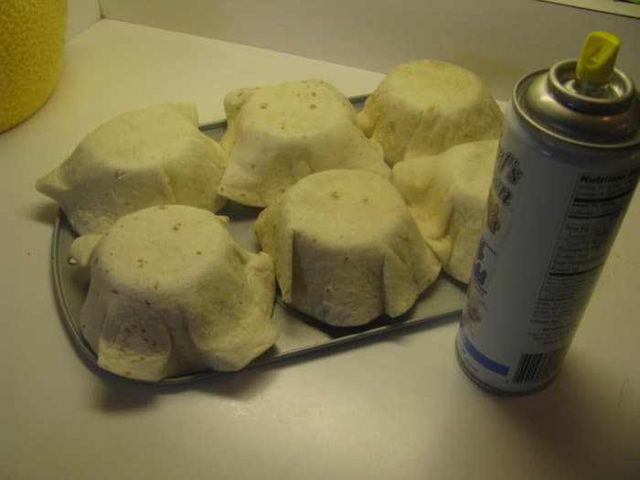 Step Four: Remove the top tin and lightly spray the tortillas with the oil spray.
