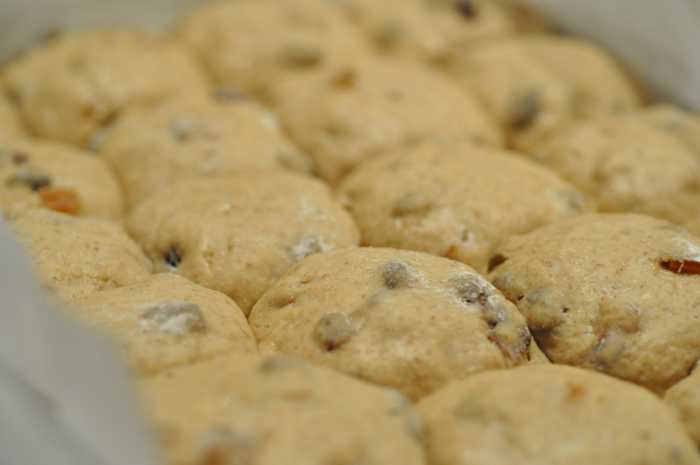 Proofed buns ready to have crosses piped on. Image: © Siu Ling Hui
