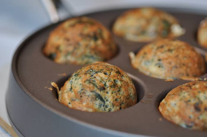 Spinach and feta ebelskivers - flipped over to complete cooking. Image: © Siu Ling Hui