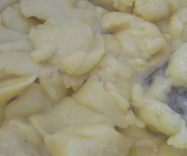 Add the eggs into the dough, a little at a time. Don't worry when the dough looks like this. It will come back together if you continue to beat it thoroughly