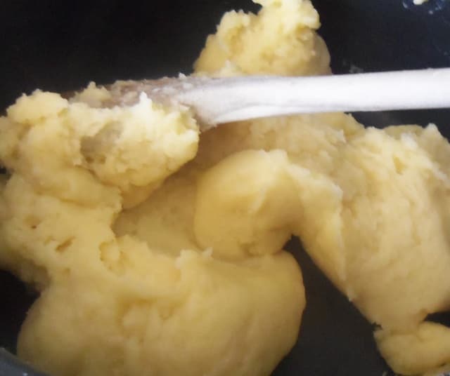 Once the milk and butter have heated, add in all the flour in one go and mix thoroughly until the dough pulls away from the sides of the pan.