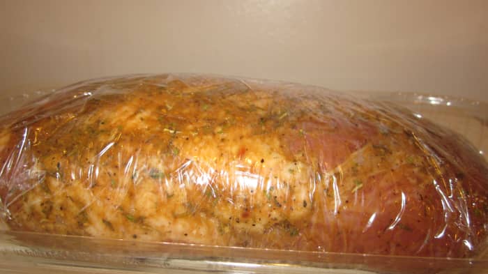 Season the pork loin and then wrap it well so that the herbs and spices can absorb before cooking.