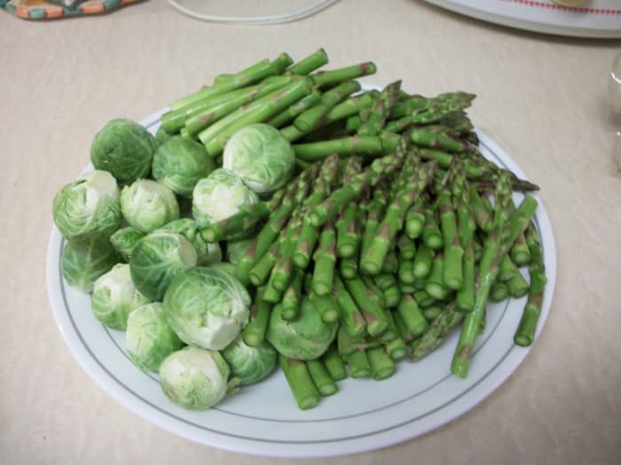Step 1. Cut the stems off of the Brussels sprouts and remove the outer leaves (these cause bitterness). Cut the asparagus into 3-4-inch pieces and discard the woody stems (at the very bottom of the stem).