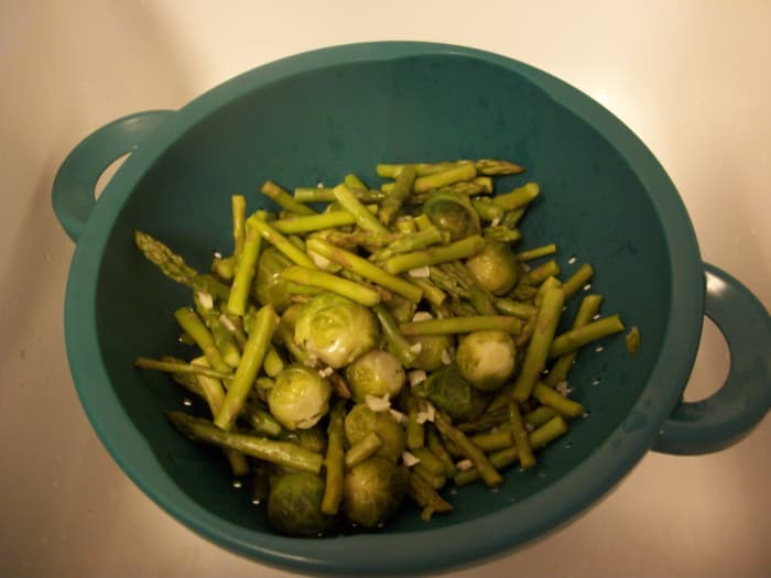 Step 5. Once vegetables are cooked to your liking, pour the contents of the pot into a strainer to drain the cooking water.
