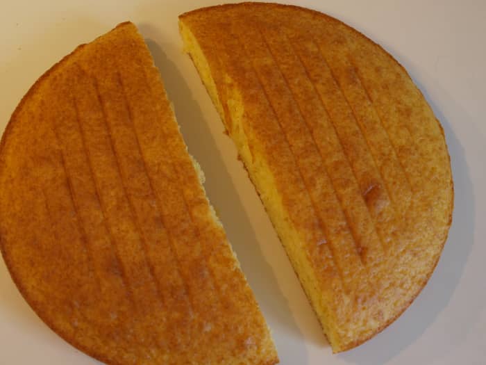 Cut the round cake evenly in half using a sharp knife. Only cut after cake is completely cooled.