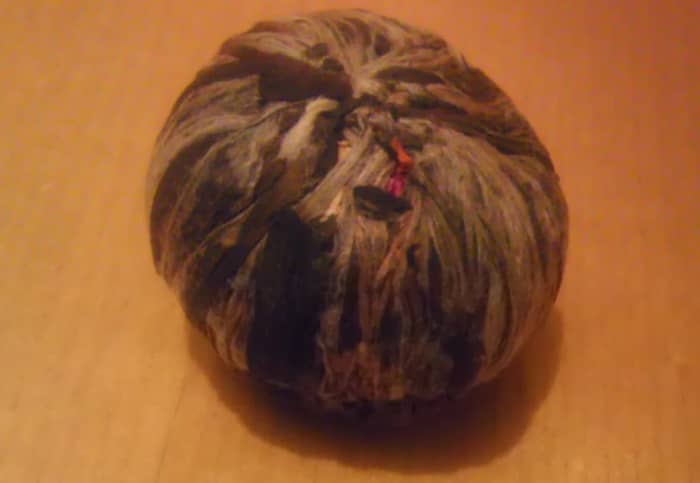 Behold! The not-so-humble, labor-intensive TeaVivre tea ball! Tea leaves and flowers are dried, then strung together in different patterns.