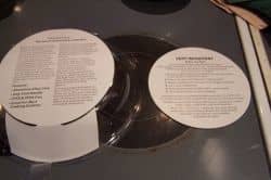 The two items shown are the overwrap that protects your pan and the inside seasoning instructions. The smaller circle also has your warranty, so don't lose it!