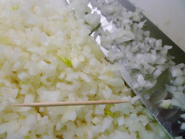 Minced onion...toothpick shown for comparison purposes as to the size of the finely minced onion.