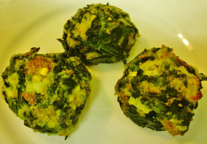 Baked spinach balls ready to be enjoyed. Just pop them in your mouth. I'll bet you will want to eat more than one!