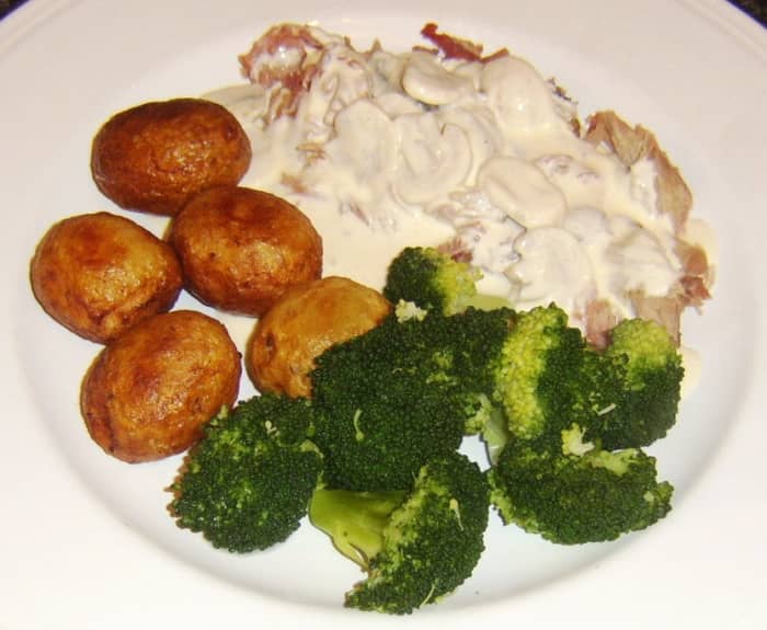 Roast rabbit saddle is plucked from the bones and served with mushroom cream sauce, roast potatoes and broccoli