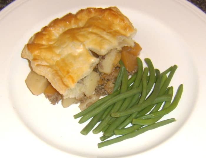 Mince, tattie and neeps are incorporated in a puff pastry pie and served simply with green string beans