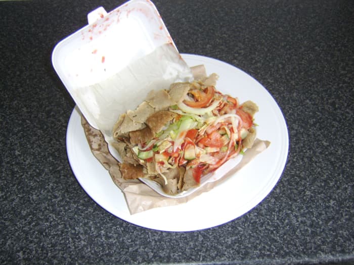 Doner kebab as purchased from a British kebab shop sees a pitta bread stuffed with lamb meat, salad and spicy sauce