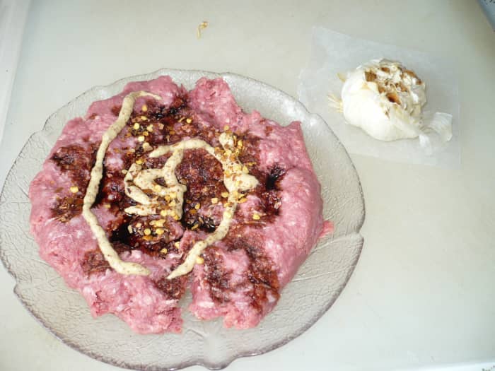 Add the mustard, soy sauce, salt, pepper, and hot pepper flakes (or not) to the lean ground beef.