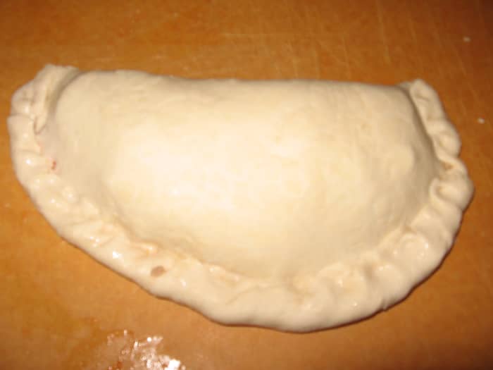 Roll the outside edge in and pinch together to seal the seam. You don't want your precious ingredients escaping.