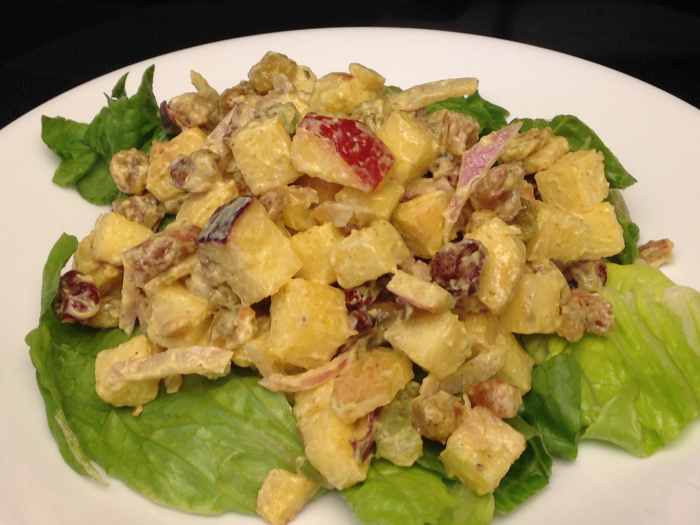 Waldorf Salad with Red Delicious and Fiji apples, raisins, and nuts, on a bed of Romaine lettuce