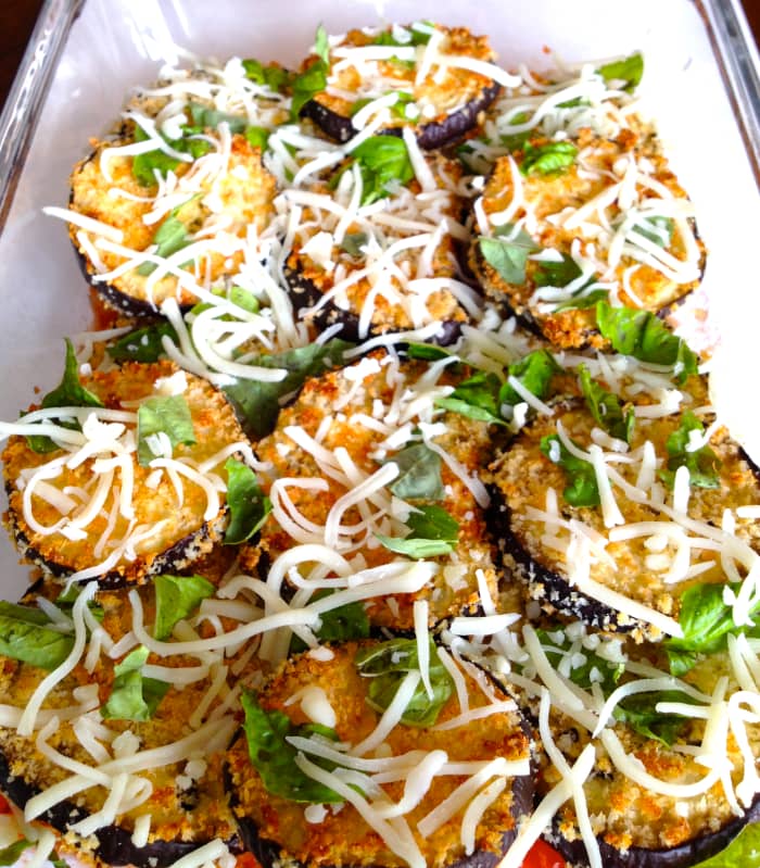 Spread sauce on the bottom of the baking dish. Layer eggplant, chopped basil, and mozzarella cheese. Spoon sauce on top.