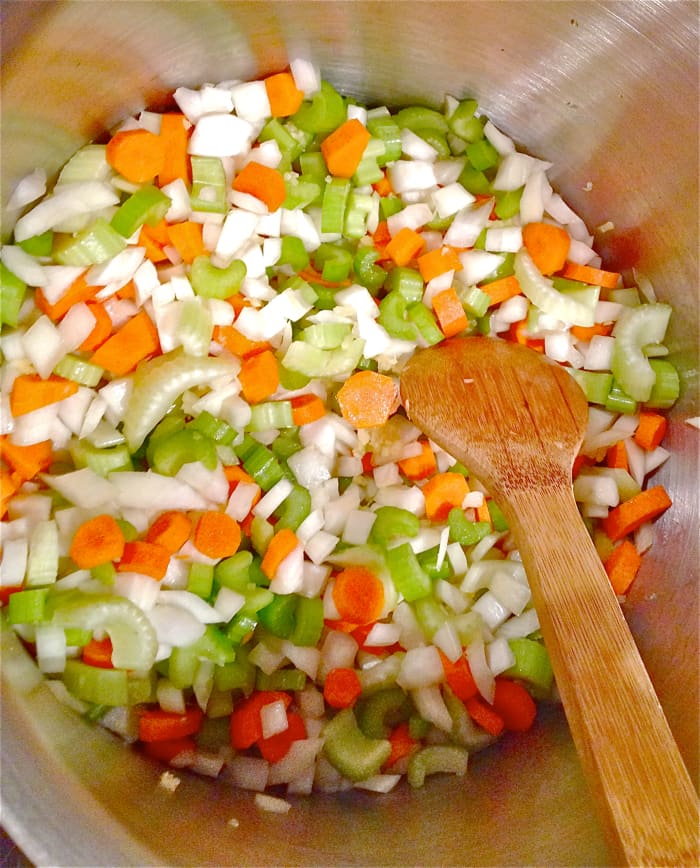 Heat oil over medium-low heat in large heavy soup pot, add onion, garlic, carrots and celery, cook until slightly tender and onions are translucent, about 10 minutes.