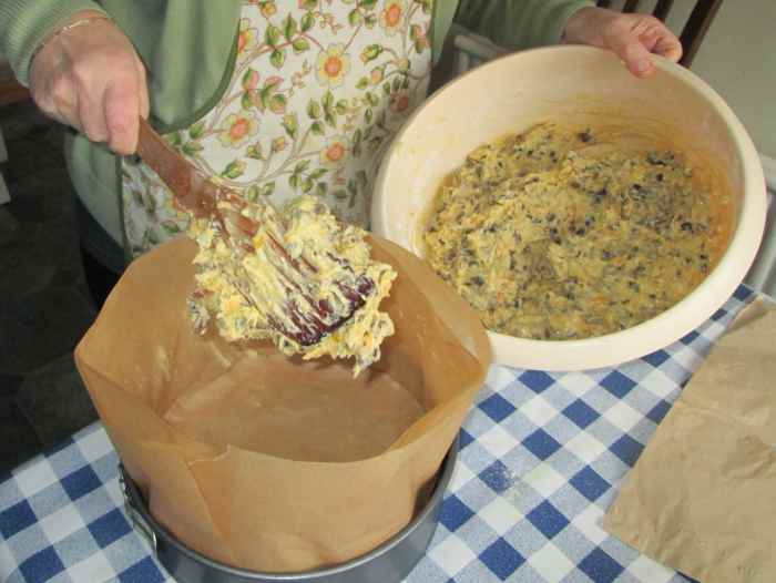 Add the cake mix to each tin. Smooth out with a wooden spoon.