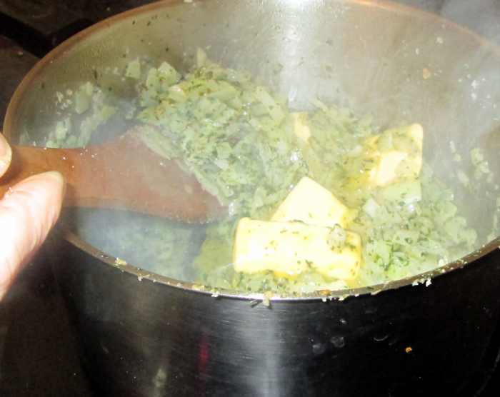 Stirring together the onions, butter, parsley and mixed herbs to make the stuffing.