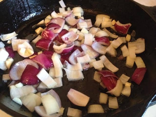 Once the butter is melted, add the onions and garlic to the pan. Allow it to cook for a few minutes.