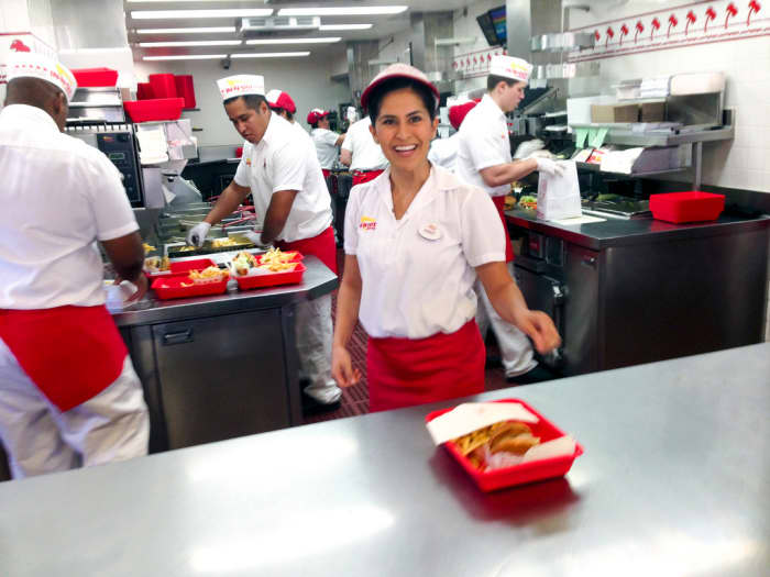This photo shows the various positions in the stand. The girl at the front is the counter greeter, and she likely took the order as well. Fry guys are behind her (left), as well as a board person (right) and cooks (back right).