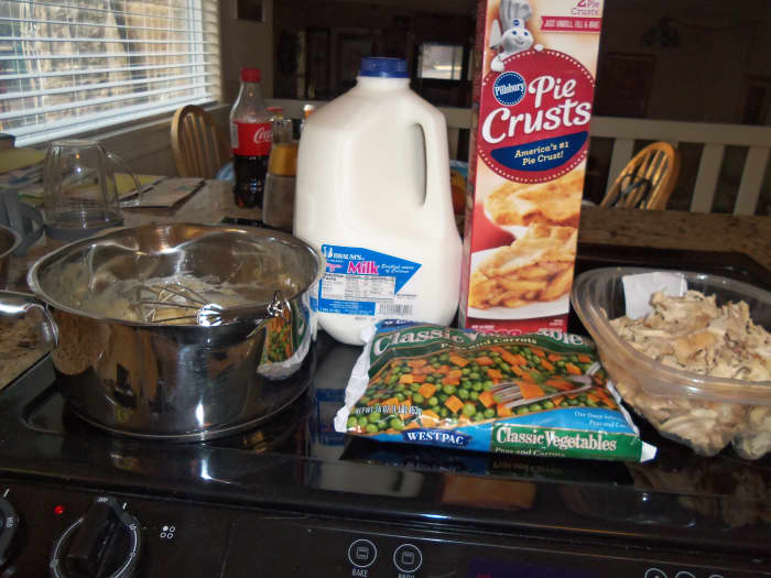 Pre-prepared pie crusts, milk, frozen peas and carrots, butter, chicken, flour, and chicken broth