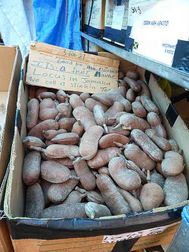 A box of stinking toe fruit for sale.