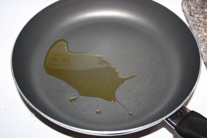 Heat oil in a large saucepan over medium-high heat. Add rice and cook, stirring occasionally, until golden brown.