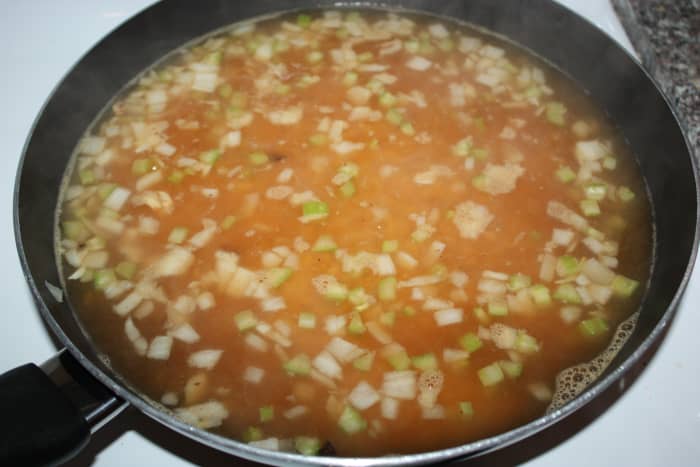 Carefully add hot vegetable stock mixture to rice mixture. Bring to a simmer, then place lid on pan.