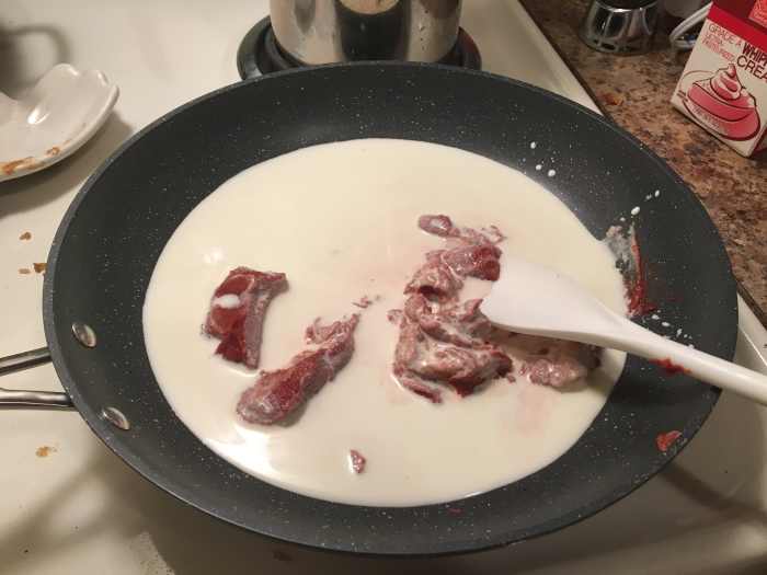 The tomato paste will dissolve in the cream and cause the cream to take on a pink color. 