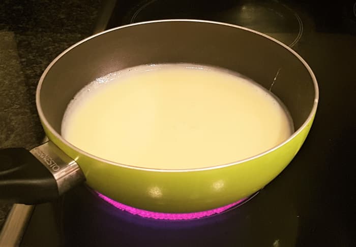 Pour the sweetened condensed milk into a heavy based pan and warm up on a medium heat. This is to help dissolve the cocoa powder. When warm, remove from the heat and stir in the unsalted butter, the cocoa powder (sieved) and the vanilla essence.