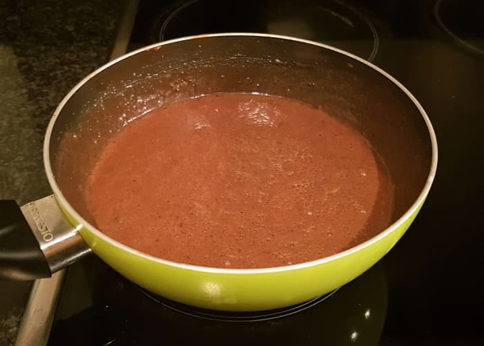 If the cocoa powder forms lumps, then blend using an electric mixer. Even if I don't see any lumps, I often perform this as a precaution. Cook on a medium-high heat for at least 10 minutes. Continuously stir the mixture.
