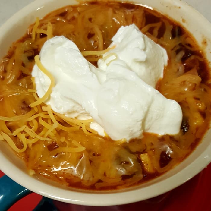My husband is much more artistic than I am, when it comes to food presentation, and he volunteered to do the toppings. As you can see, he gets blissfully carried away with cheese and sour cream.