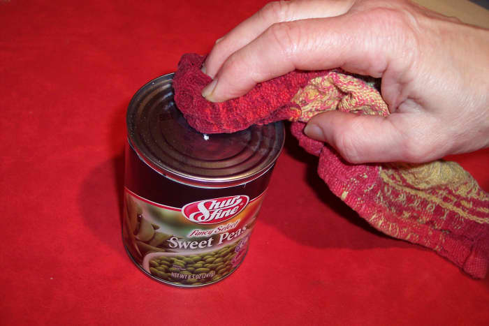 The top of the can should be washed off before being opened. If any contaminants have deposited themselves there, they can be transferred to the inside of the can by insertion of the cutting edge of the can opener.