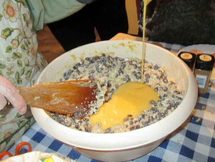 Mixing in the ingredients for a Christmas plum pudding