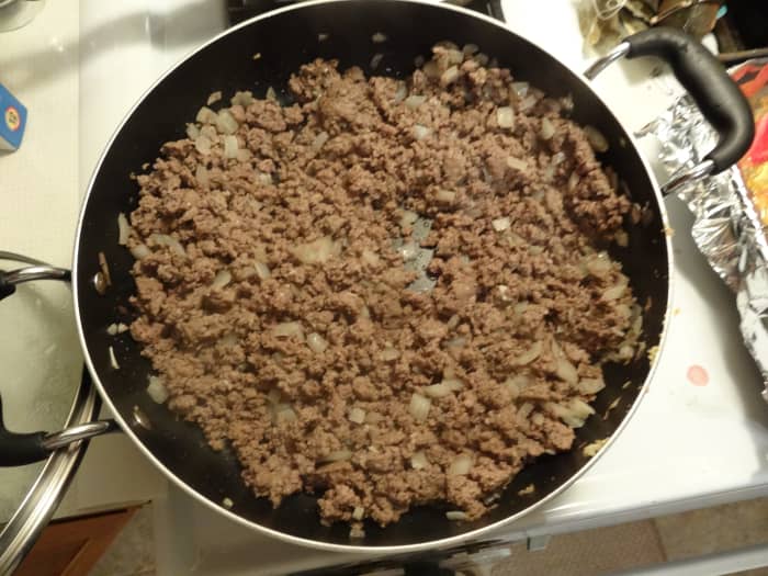 While tomatoes are roasting, cook beef, onion, and garlic in a large skillet over medium high heat until thoroughly cooked (8–10 minutes). Drain, add chili powder, cumin, and coriander then cook an additional 1–2 minutes.