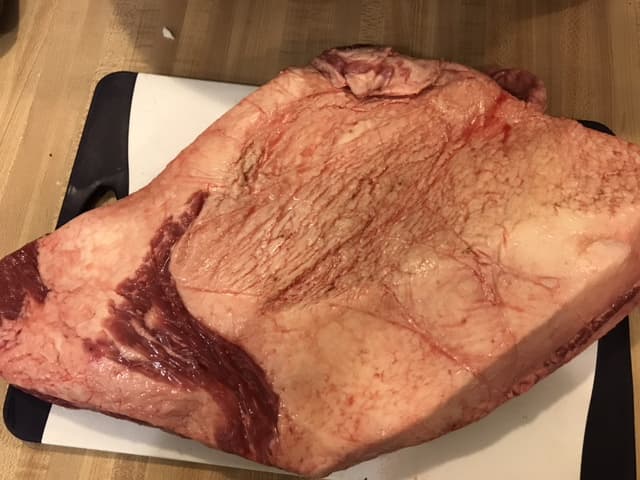 One side of the brisket will have a thick layer of fat - called the fat cap. Season this side as well, and cook the brisket with this side up.