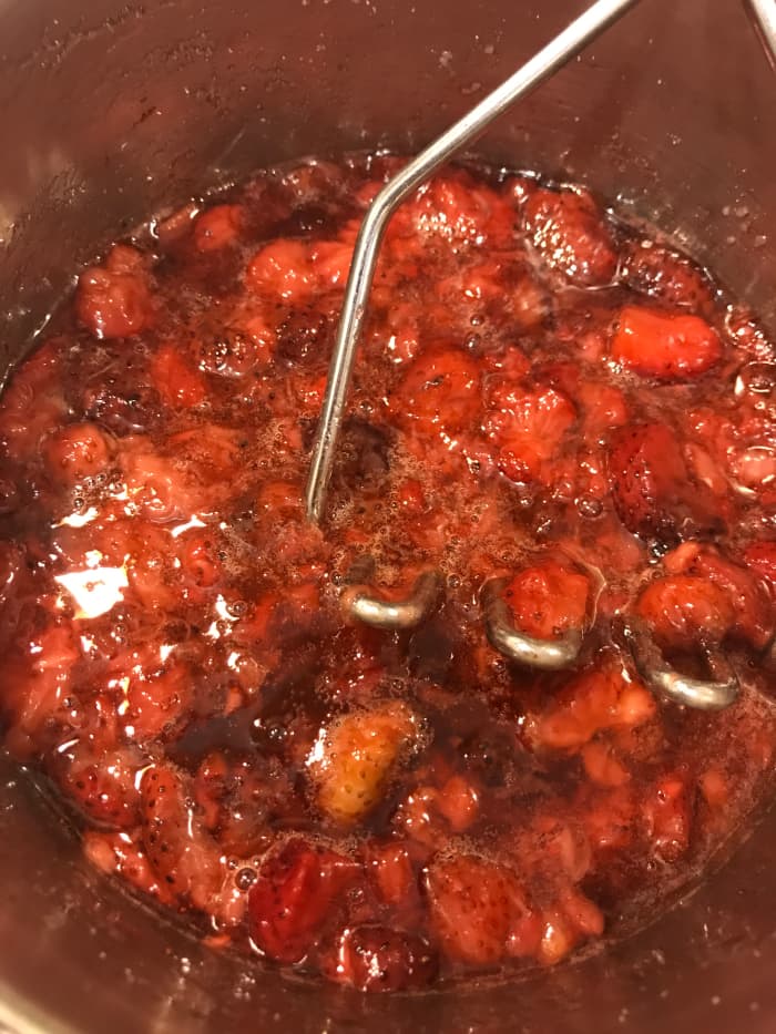 Crushing the berries as they cook helps release every last bit of their juices. A potato masher makes this a simple job, but use whatever you have.